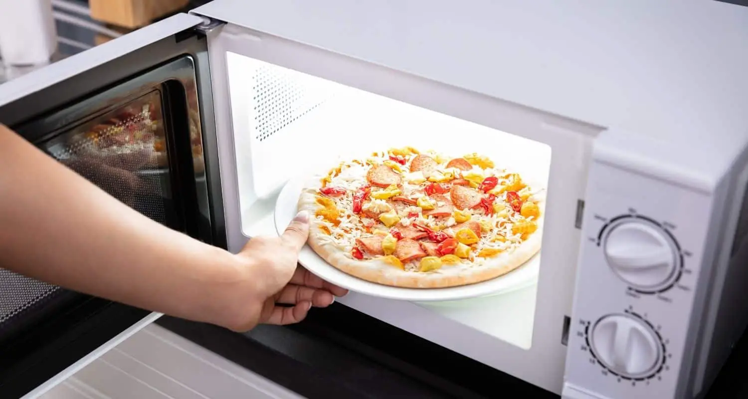 Why does pizza crust gets hard in the microwave?